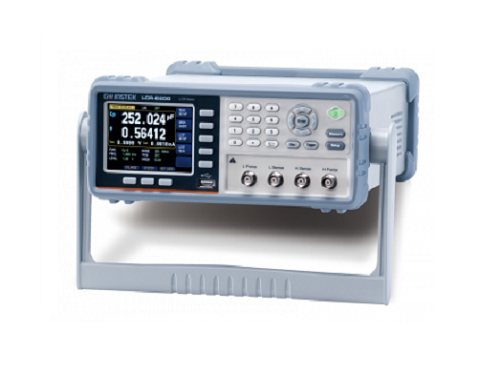 Technician performing inspection work on an LCR meter used for electrical measurement